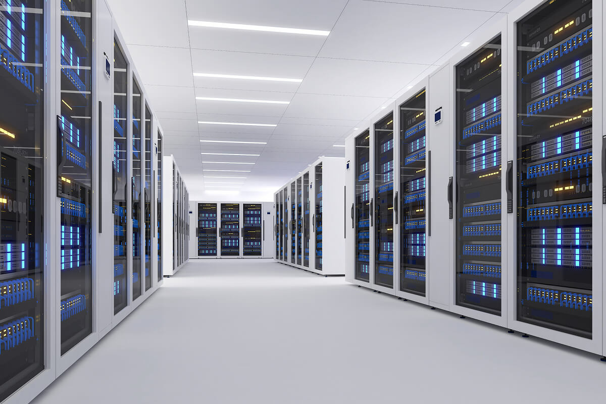 Rows of server racks with blue LED lighting in a finished data center facility