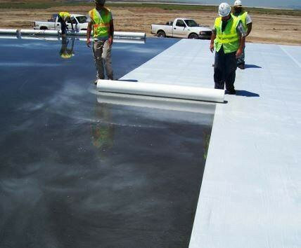 Concrete cover being rolled onto fresh concrete